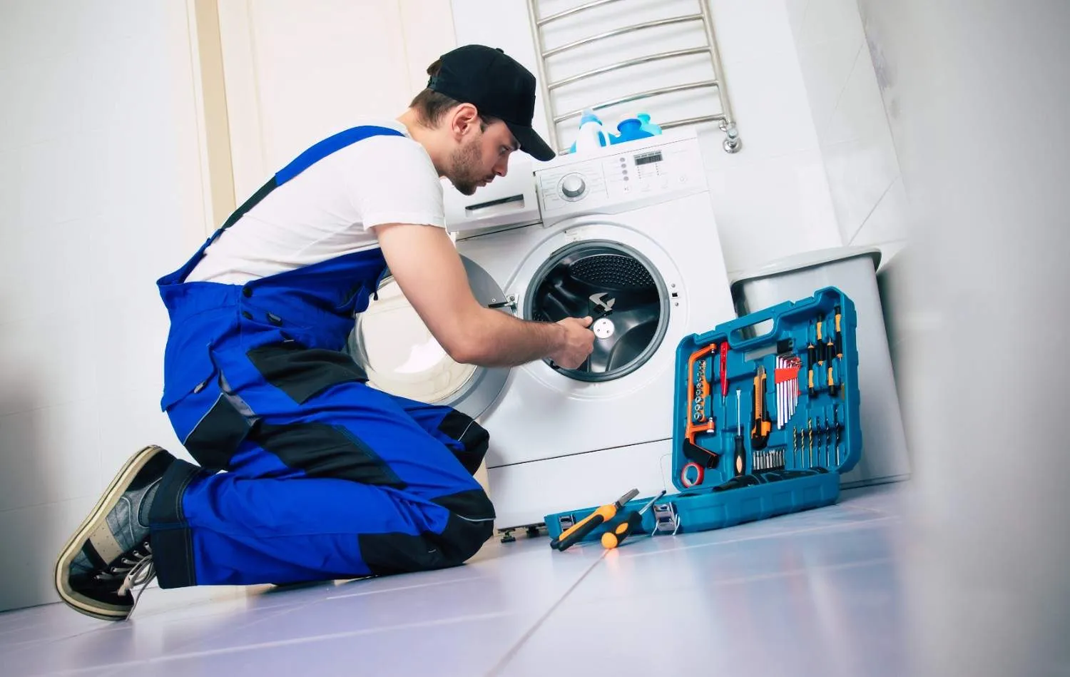 Technician repairing a front load washing machine